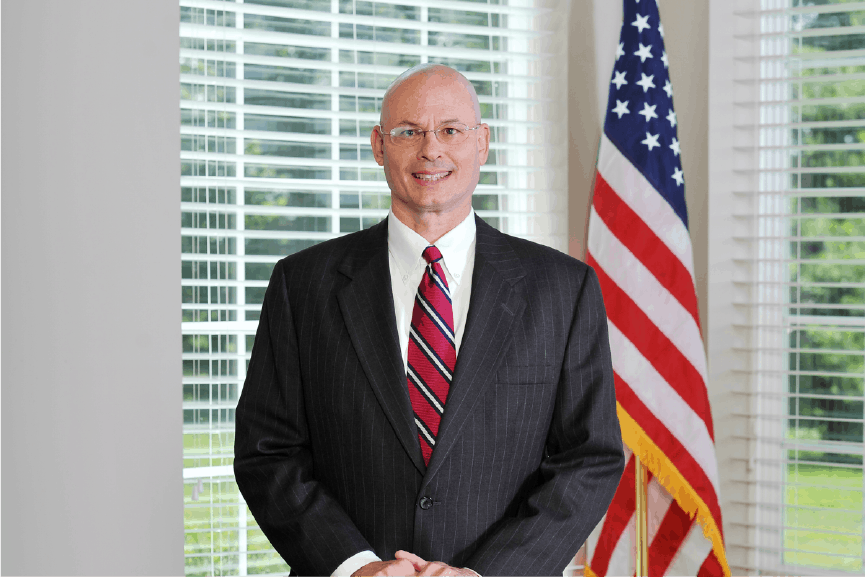 tom dunn in suit and tie smiling