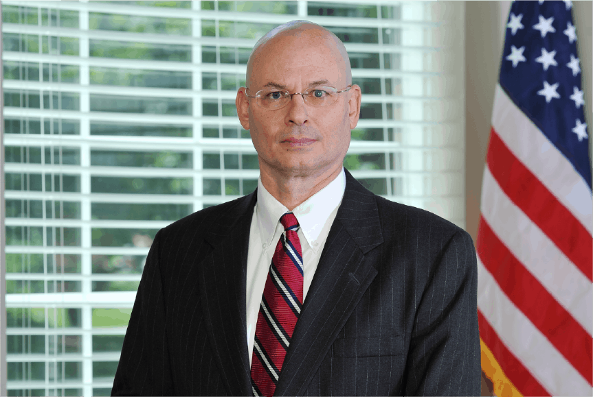 close up tom dunn in suit and tie serious