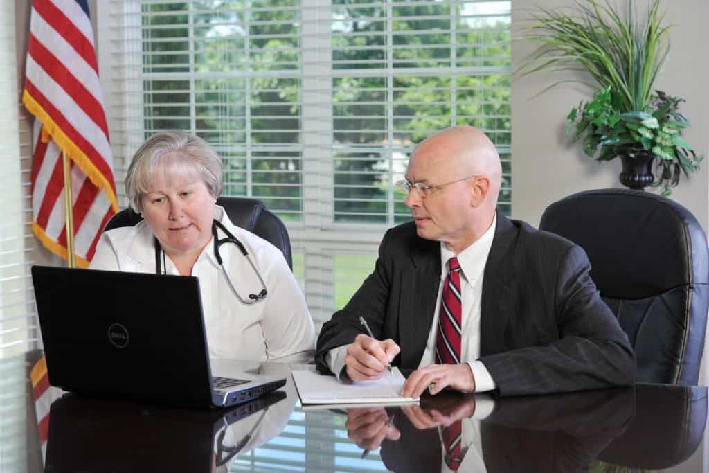 tom dunn and woman doctor on computer