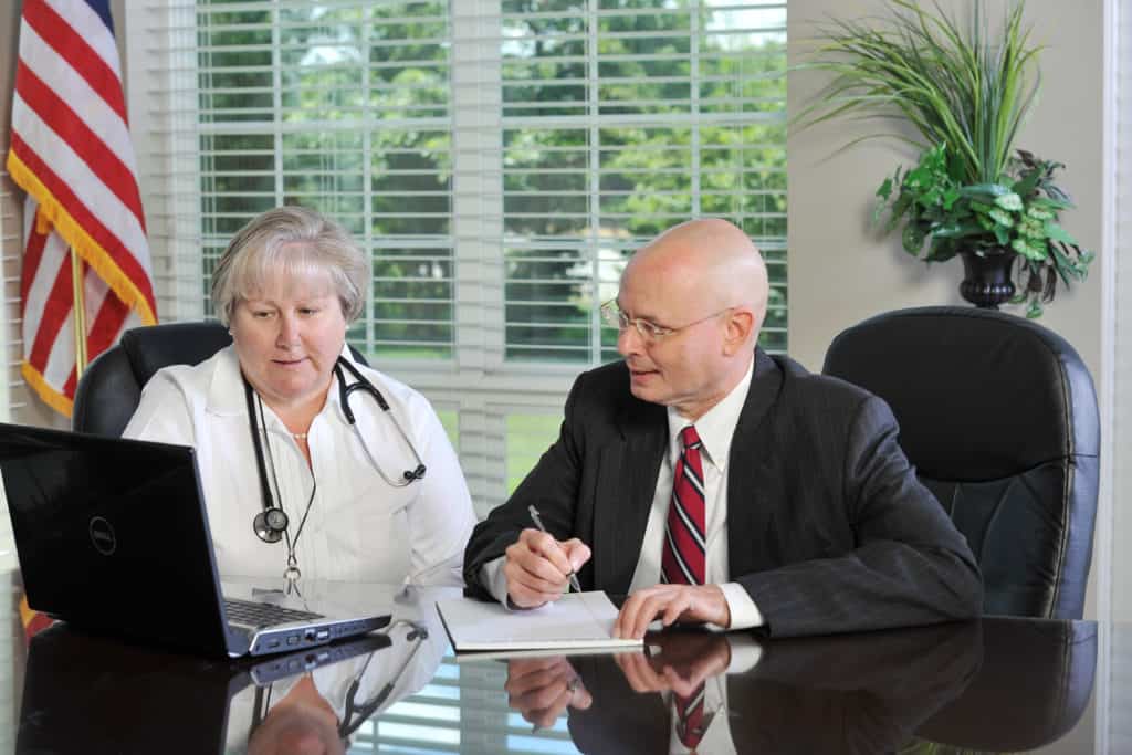 tom dunn and woman doctor on computer