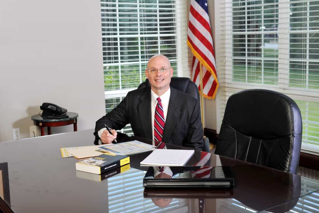 tom dunn sitting with papers