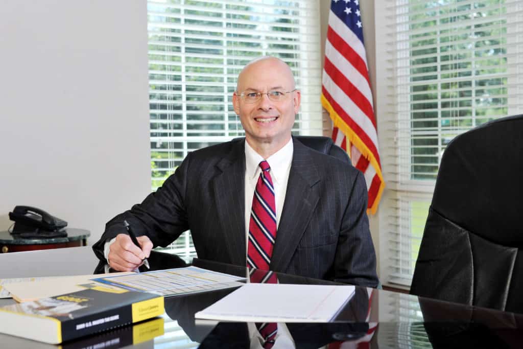 tom dunn sitting with papers