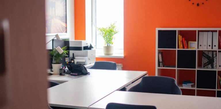 empty office with orange walls and a printer
