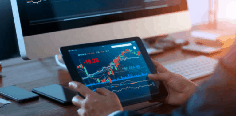 man holding a tablet displaying charts
