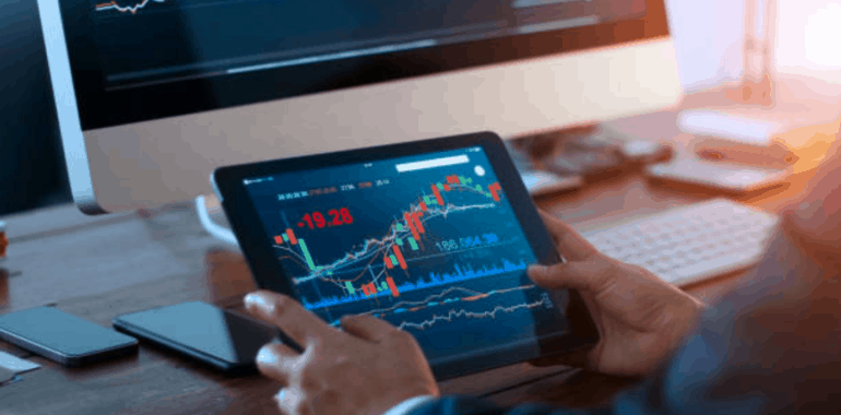 man holding a tablet displaying charts