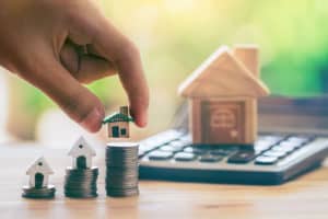 tiny houses on coin stacks