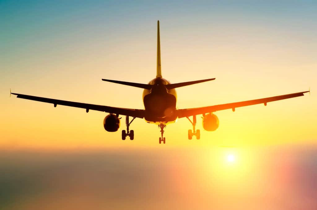 Airplane landing at sunset