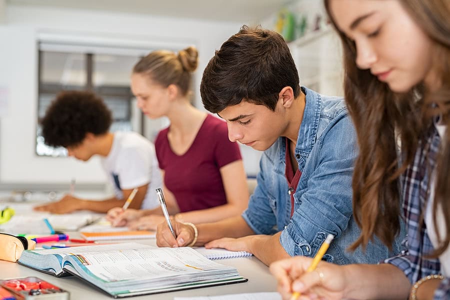 students writing on paper