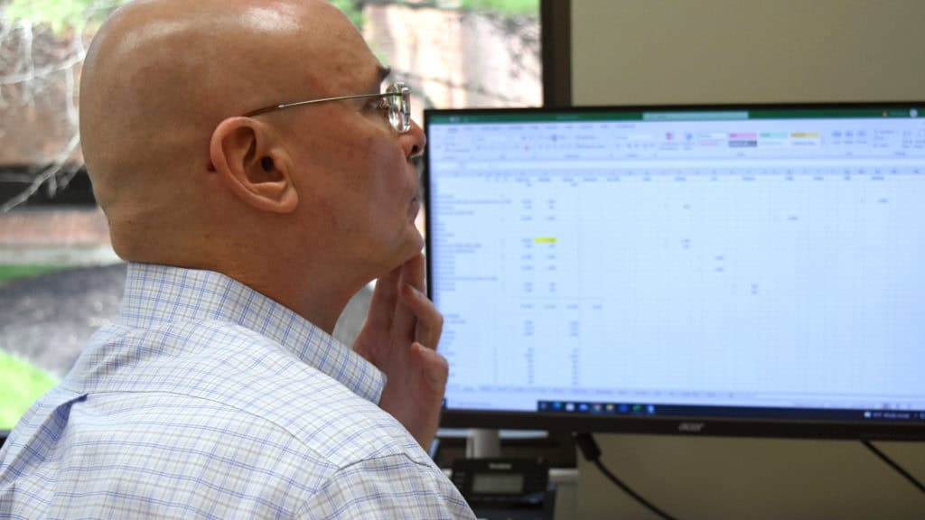 Person working at a computer desk.