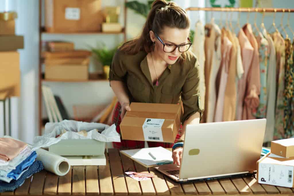 Person organizing packages at workspace.